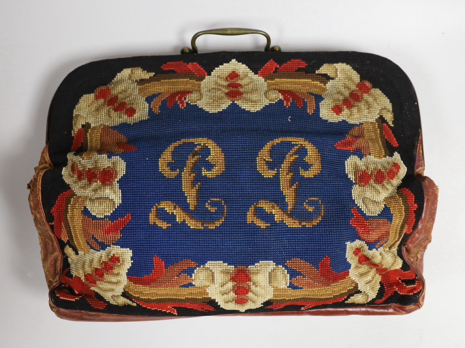 A 19th century needlework and leather bag and a leather Gladstone bag, needlework bag frame 40cms wide